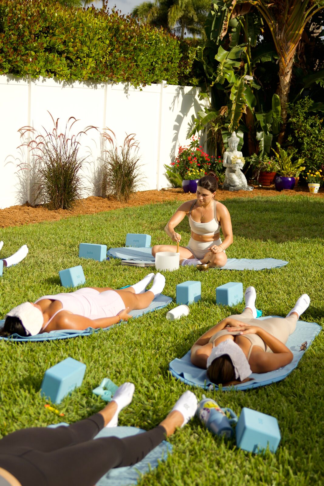 Outdoor sound-bath setup with mats, towels and blocks